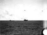 Yorktown dead in the water, escorted by destroyer Russell, 1330, 4 Jun 1942; two SBD-3 scout bombers flew overhead