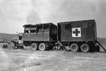 US Army CCKW 2 1/2-ton 6x6 cargo truck pulling rear half of another, forming the Mobile Optical Section of the 12th Medical Depot Company, US 5th Army, Volterro, Italy, 9 Aug 1944