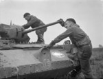 British 1st Armoured Division tankers climbing aboard their Covenanter tank, Britain, 20 Dec 1941