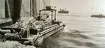 Loaded US Army DUKW shoving off from stores ship, date unknown