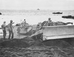 US Marine Corps bulldozer pulling a DUKW on the beach of Iwo Jima, Japan, 1945