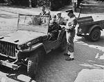US Army Captain Thomas Ryan checking in civilian photo technicians at a checkpoint in Potsdam, Germany, 14 Jul 1945; note Willys MB jeep; the military policeman was Corporal Charles Christie