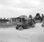 Riflemen of 1st Battalion Royal Ulster Rifles, 6th Airlanding Brigade, UK 6th Airborne Division aboard a jeep and trailer, Normandy, France, 6 Jun 1944; note Horsa glider in background
