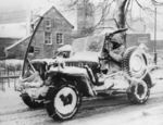 A jeep of US Army 30th Infantry Division in Belgium, 27 Jan 1945; note Browning M1919 machine gun, radio antenna, anti-decapitation bar, and unusual spare tire location