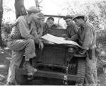 US personnel in the Pacific checking their map on a Willys MB slat-grille Jeep, 15 Mar 1943