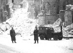 Soviet troops in Warsaw, Poland standing beside a Willys slat-grille Jeep sent to USSR via lend-lease, 1945