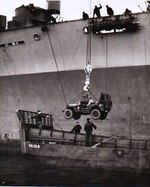 A Jeep being lowered into an LCM from Attack Transport USS Joseph T. Dickman (APA-13 – former SS President Roosevelt), manned by USCG personnel off Normandy, June 1944. Photo 1 of 2