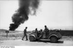 German troops with a Type 82 Kübelwagen with the fires of Tobruk, Libya in the background, Aug-Sep 1942