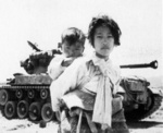 Korean civilians in front of a US M46 medium tank, 1950s