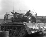 M46 medium tank of US 1st marine Tank Battalion, Korea, 25 Mar 1953; note bulldozer attachment and anti-rocket wire screen