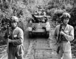 Chinese troops posing with Thompson submachine guns and M3A3 light tanks, en route to Bhamo, Burma, Dec 1944