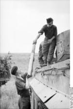 German tank crew transferring rounds of ammunition into a Tiger I heavy tank, near Kursk, Russia, summer 1943, photo 3 of 5