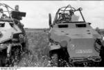 Two German SdKfz. 251/6 halftrack vehicles in the field, crews studying field maps, Russia, Jun 1942