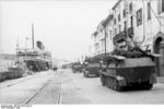 SdKfz. 251/7 halftrack vehicles at a port in Southern France, 1942, photo 1 of 3; note passenger ship Maréchal Lyautey in background