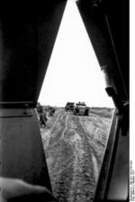 German troops and SdKfz. 251 column, viewed from inside another SdKfz. 251 halftrack vehicle, Russia, Oct 1941