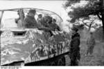 A German Army Skijäger (ski trooper) junior officer speaking with his senior officer in a SdKfz. 251/3 halftrack vehicle, Russia, Feb 1944