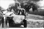 German troops transporting a wounded soldier with a SdKfz. 251 halftrack vehicle, Eastern Front, 21 Jun 1944, photo 1 of 2
