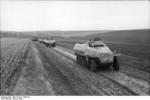 A SdKfz. 251/9 halftrack vehicle leading a column of others down a road in southern Ukraine, Jan 1944