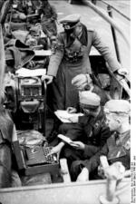 German General Heinz Guderian in a SdKfz. 251/3 halftrack vehicle, France, May 1940, photo 1 of 6; note early 3-rotor Enigma machine