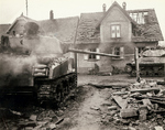 Two US Army medics amidst wrecks and rubble in a German town, 1944-1945