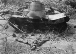 Japanese Type 95 Ha-Go light tank knocked out by Australian anti-tank fire during Battle of Muar in Malaya, 28 Jan 1942; note dead crew members nearby