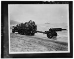 US Army two-and-a-half ton prime mover towing a 105 mm Howitzer M2 on the Algerian beach, North Africa, 1943