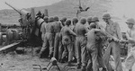 Men of Battery C, 7th Battalion, USMC III Amphibious Corps Artillery cleaning the bore of their 155mm Gun M1, Guam, Mariana Islands, 1944