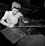 Female worker engraving Chinese characters on weapons made for export to China, John Inglis and Company factory, Toronto, Canada, 1940s