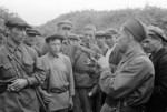 A Soviet soldier teaching partisan fighters how to operate a Browning Hi-Power handgun, near Smolensk, Russia, 23 Aug 1941