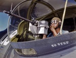 US Navy ordnanceman Jesse Rhodes Waller posing with a M1919 Browning machine gun next to a PBY Catalina aircraft, Naval Air Station, Corpus Christi, Texas, United States, Aug 1942, photo 2 of 3