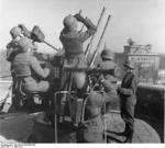Crew of a Flakvierling 38 anti-aircraft gun atop the Berlin Zoo flak tower, Berlin, Germany, 16 Apr 1942; note range measuring device in foreground and radar station in background