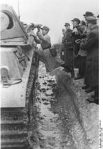 German soldier instructing Volkssturm militiamen on the use of 3 HL shaped charges on a Panther tank, Germany, Jan 1945