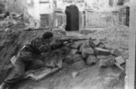 Polish resistance fighter with captured German Kar98k rifle outside the Field Cathedral of the Polish Army on Dluga Street, Warsaw, Poland, late Aug 1944