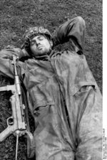 German paratrooper taking a nap with his MP 40 submachine gun at his side, Normandy, France, 1944
