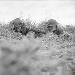 British Rifleman Reg Oates and Sergeant James Woodward with a PIAT anti-tank launcher near Caen, France, 1944