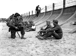 Canadians guarding captured German troops, Berniers Sur Mer, France, 6 Jun 1944; note Sten gun
