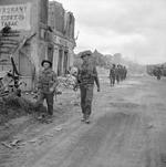 Troops of A Company, 6th Durham Light Infantry Regiment, British 50th Division in Grandcamp-Maisy, France, 11 Jun 1944; note Sten gun