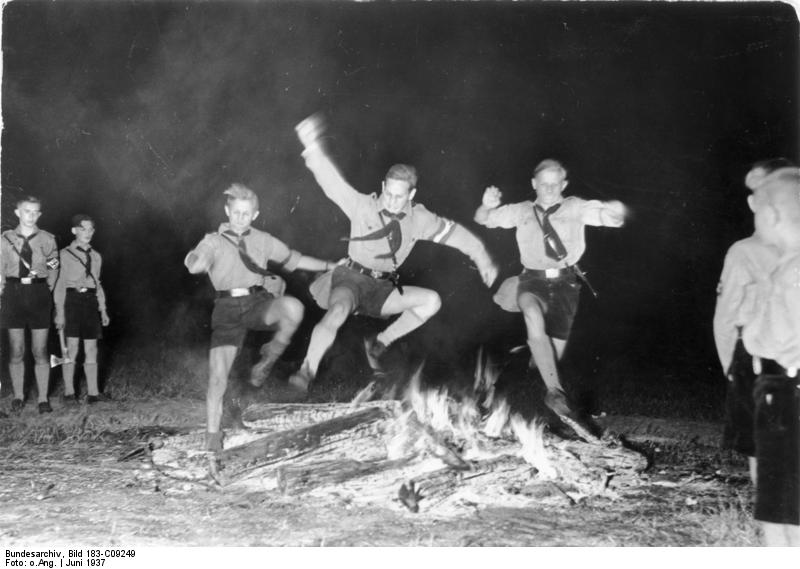 Hitler Youth members jumping over the solstice fire, Berlin, Germany, Jun 1937