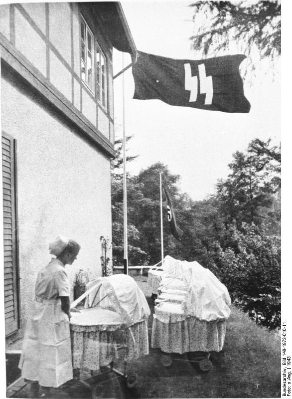 Maternity nurse at a Lebensborn facility, 1943; note SS and Nazi German flags