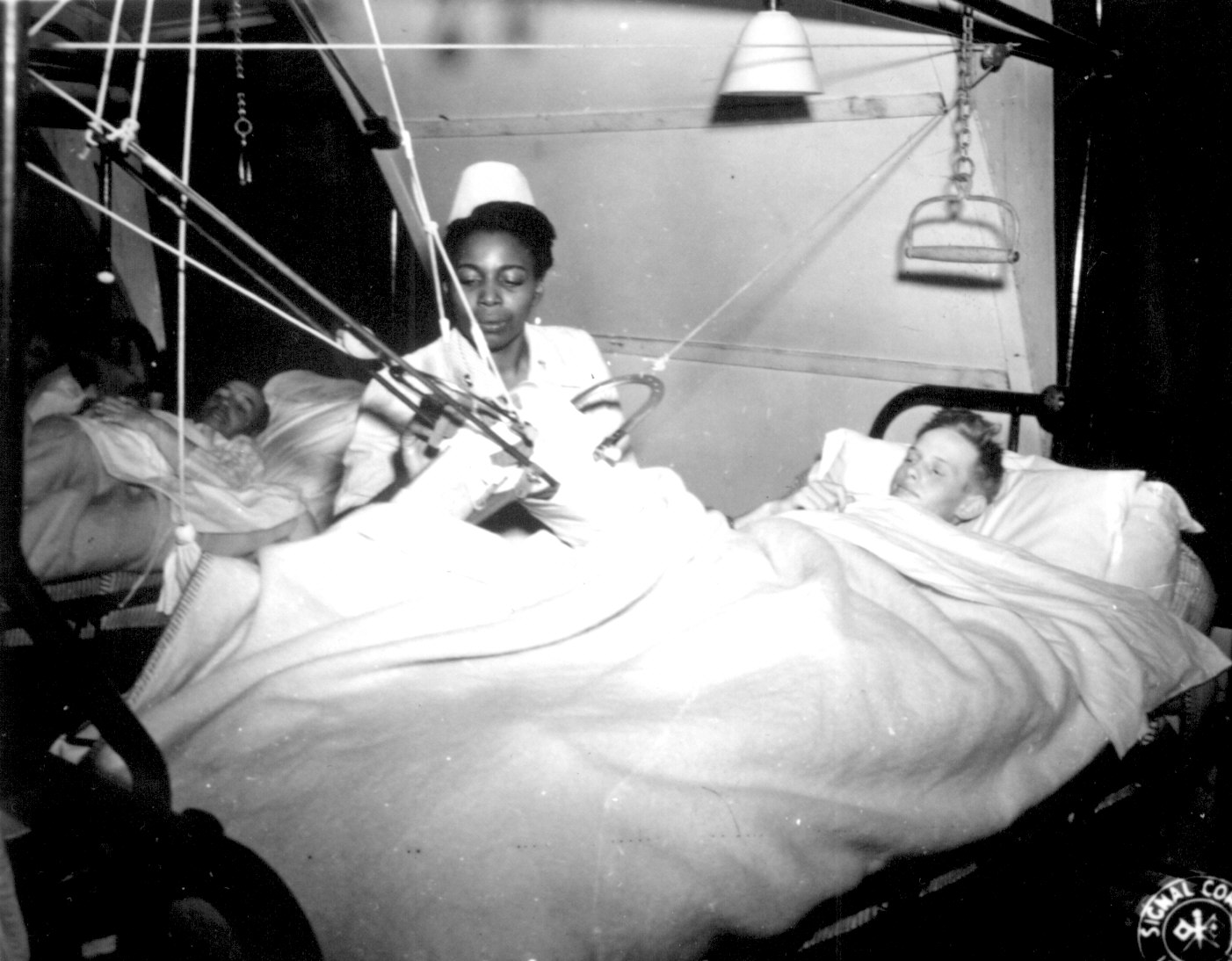 African-American US Army nurse Lieutenant Florie E. Gant tending a prisoner-of-war patient, England, UK, 7 Oct 1944