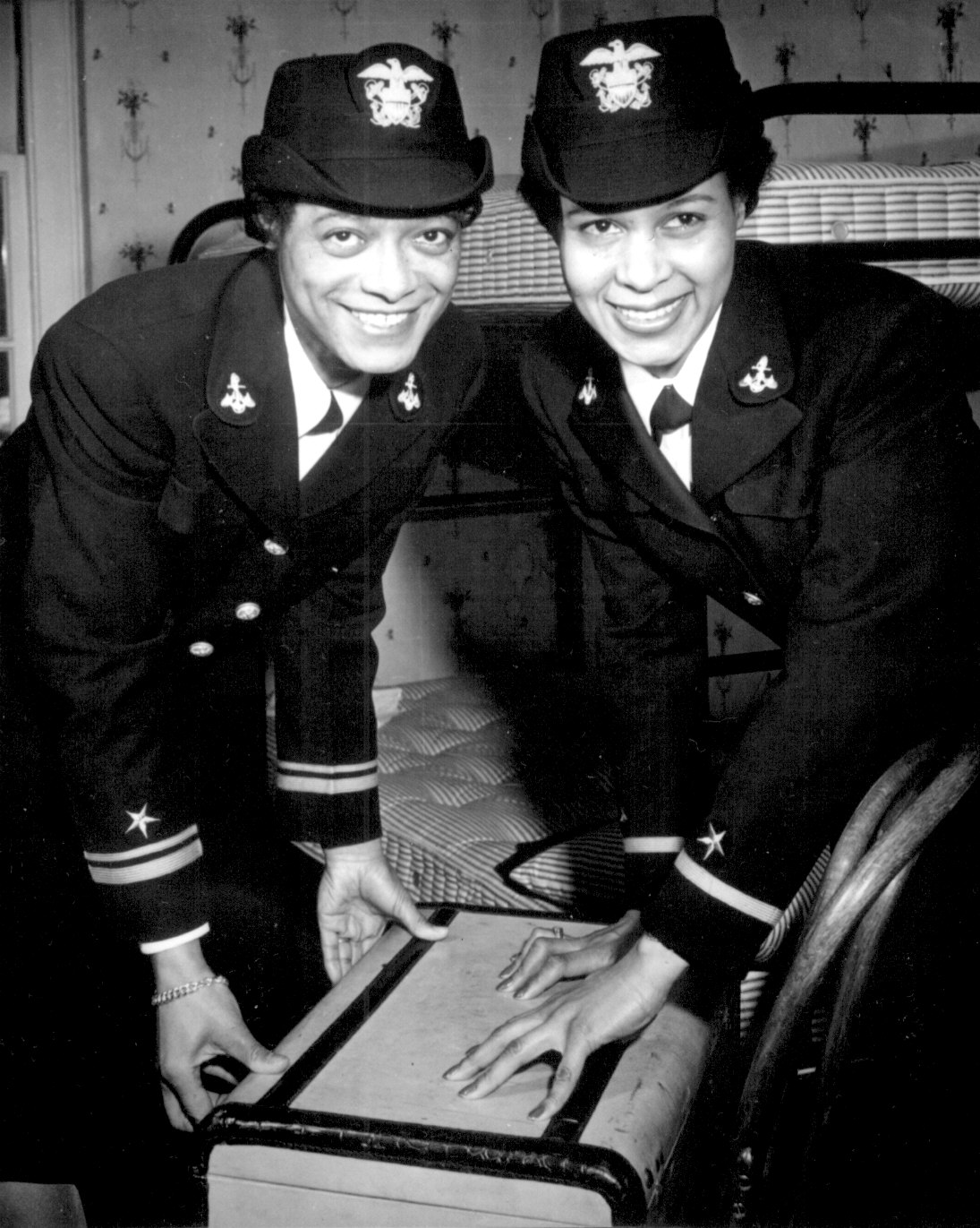African-American US Navy WAVE Lt. (jg) Harriet Ida Pickens and Ens. Frances Wills posing at their quarters at Naval Reserve Midshipmen's School, Northampton, Massachusetts, United States, 21 Dec 1944