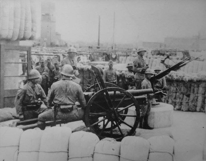 Japanese naval infantrymen with a field gun, circa 1940s