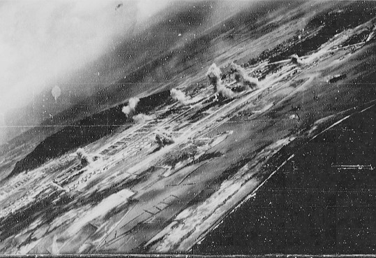 View of Toshien (now Zuoying) harbor and airfield, Takao (now Kaohsiung), Taiwan, 12 Oct 1944, photo 1 of 3; photo taken from aircraft of USS Wasp