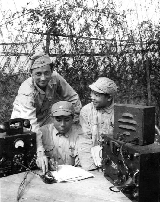 US Army captain instructing radio communications to two Chinese soldiers, China, 1940s