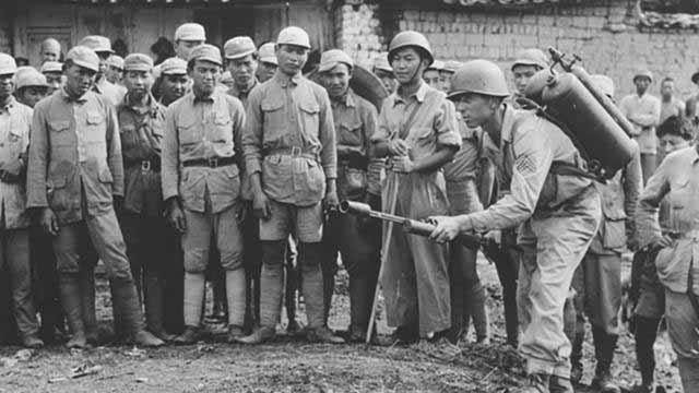 US soldier instructing flamethrower operations to Chinese soldiers, China, 1940s