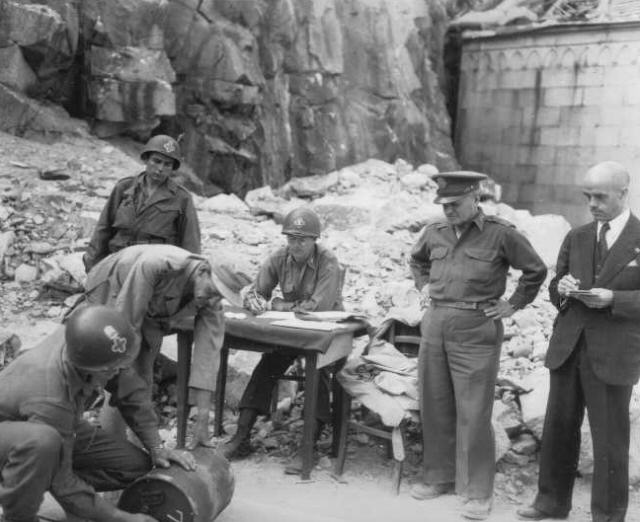 Staff Sergeant B. Kreselewski of 337th Field Artillery Battalion, US 88th Division numbering a keg of gold, Fortezza, Italy, 17 May 1945