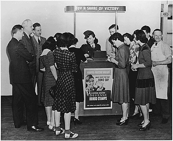 An American woman promoting war bonds and stamps, 1943