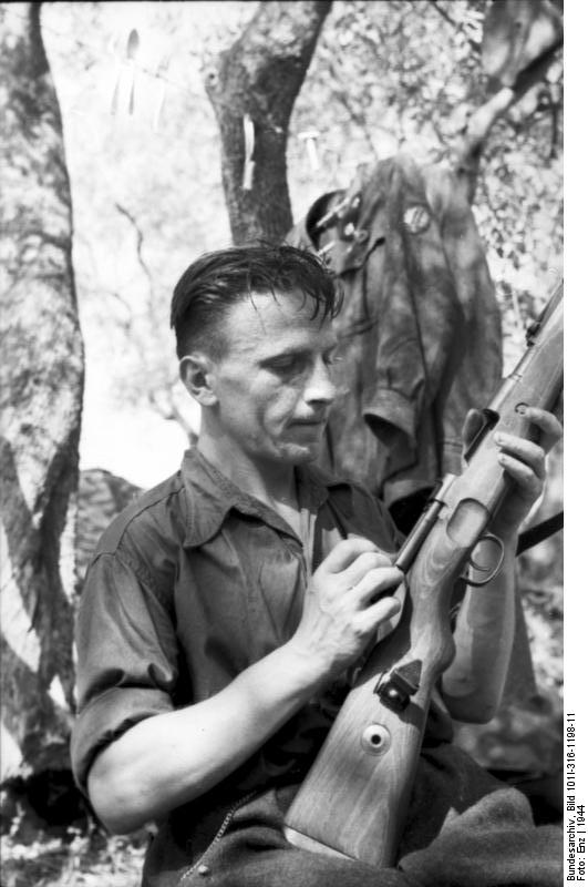 Italian soldier cleaning his rifle, Italy, 1944