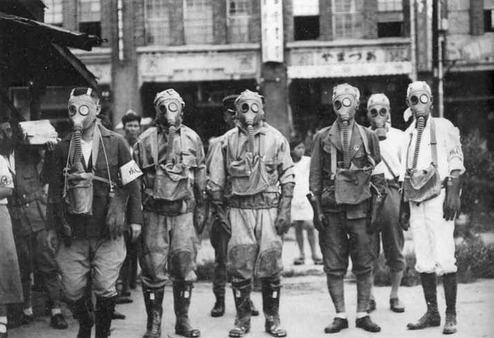 Japanese policemen donning gas masks during an air raid exercise, Taiwan, 1934