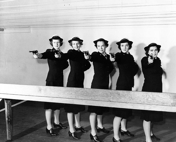 WAVES personnel posing with High Standard Model B pistols at an indoor range at Treasure Island Naval Base, California, United States, 11 Feb 1943